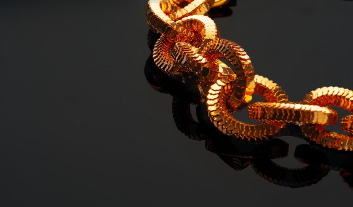 golden chain necklace on black background with ref vtjk95q