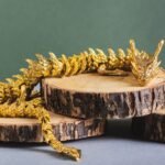 metal dragon on truncks of tree on green backgroun uptn5hu