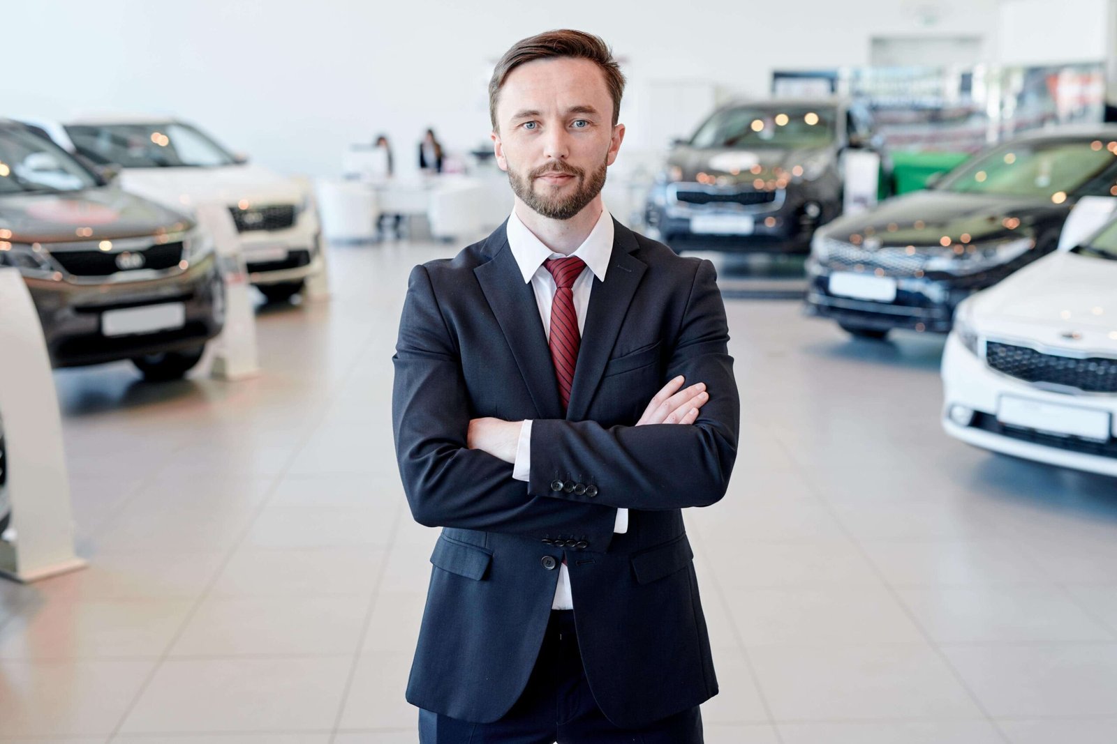 car salesman posing in showroom z4feb2p scaled 1.jpg