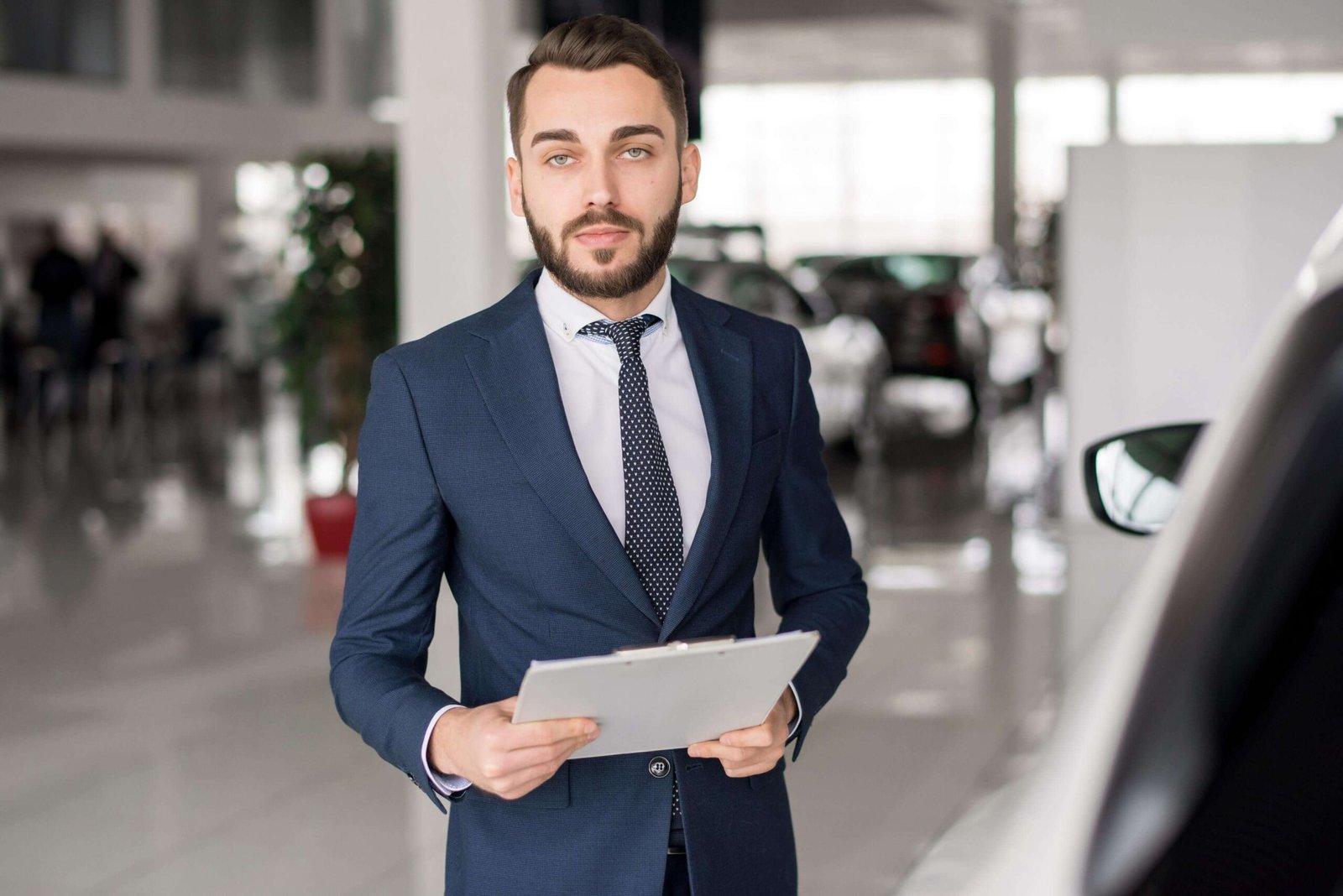 successful car salesman in showroom 7gv5spk scaled 1.jpg